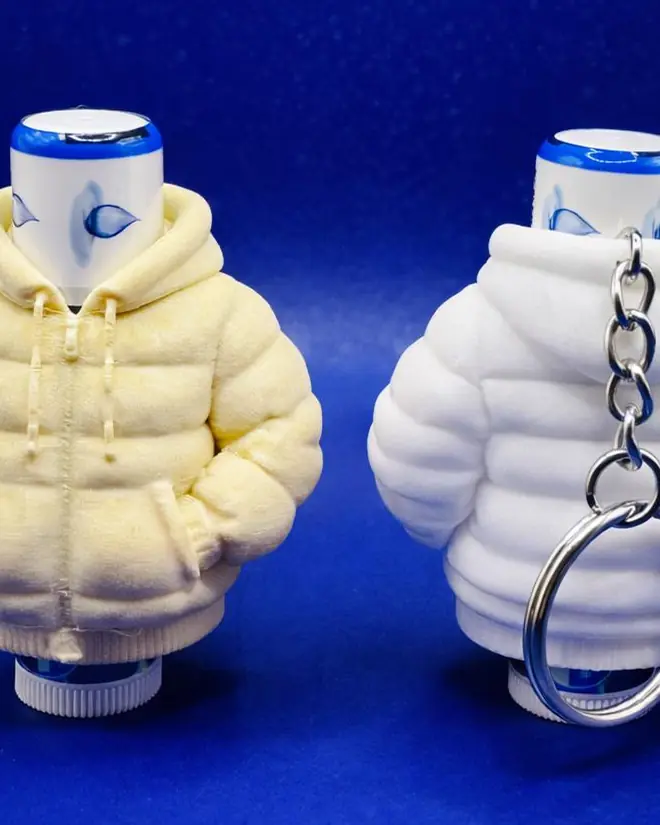 Two cream puffer jacket keychains that open to hold a lip balm