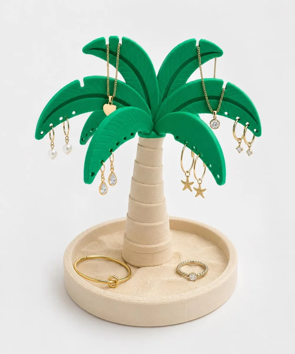 Green and sand palm tree jewelry stand hung with necklaces, beside a plant